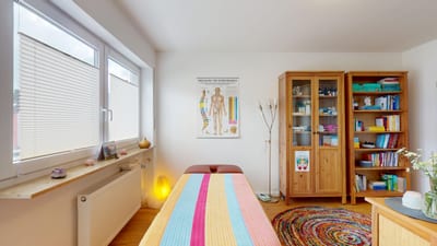Behandlungsraum mit Meridian-Übersicht in der Naturheilpraxis Christine Sack, Erding